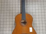a guitar that is sitting on the floor in the room