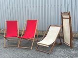 three chairs that are next to each other in front of a building