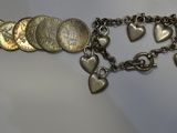a close up of a bracelet with a bunch of coins on it