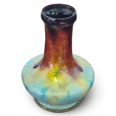 a vase that is sitting on a white surface