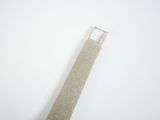 a silver tie that is laying on a white surface