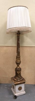 a lamp that is sitting on a table next to a wall
