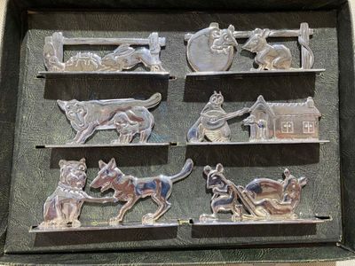 a metal tray that has a bunch of metal animals on it