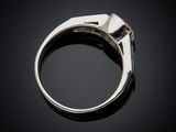 a close up of a silver ring on a black surface