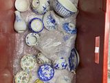 a red container filled with lots of blue and white dishes