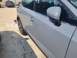 a silver car parked in a parking lot next to other cars