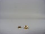 a pair of gold stud earrings on a white surface