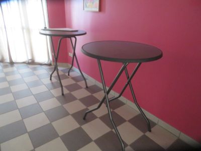 two tables that are sitting on a checkered floor