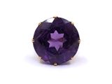 a close up of a purple stone ring on a white background