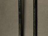 two baseball bats and a ball on a table