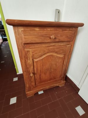 un petit meuble en bois dans un coin de la pièce