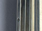 a close up of a metal pole with a clock on top of it