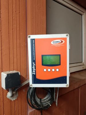 a control panel attached to the side of a building