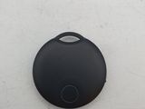 a close up of a black button on a white wall