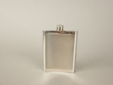 a flask with a wooden handle sitting on a table