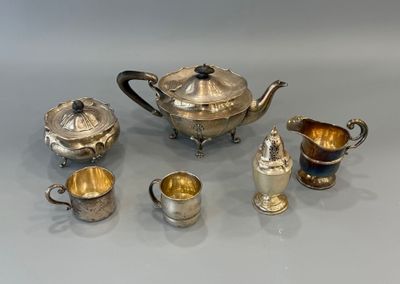 un assortiment d'argenterie comprenant une théière, des tasses et des soucoupes