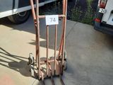 a luggage cart with a number on it in front of a van