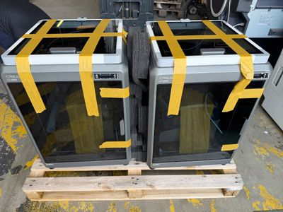 two microwaves sitting on a pallet in a warehouse