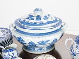 a table with a lot of blue and white china on it