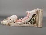 a white and pink sculpture on a gray surface
