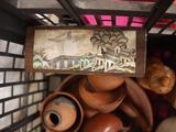 a basket full of clay pots and pots with a picture on it