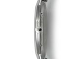 the back of a watch on a white surface with a white background