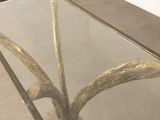 a glass table with a plant inside of it