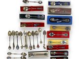 a lot of spoons and spoon knives on the table