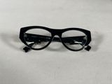 black glasses on a white surface with a white background
