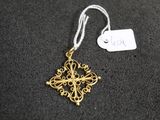 a close up of a gold ornament with a tag on it