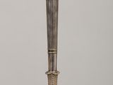 a silver candle holder sitting on a wooden table