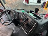 a dashboard of a bus with a steering wheel and dashboard controls