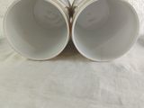two cups that are sitting on a table