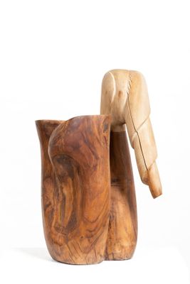 a wooden duck that is sitting next to a wooden cup