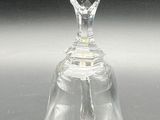 a clear glass bell on a table with a black background
