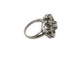a close up of a silver ring with a flower on it