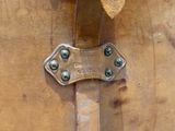 a close up of a brown suitcase with a metal handle
