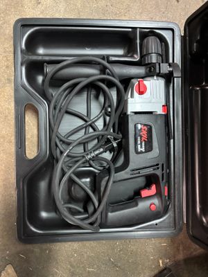a black box with a cord in it on the floor