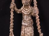 an image of a statue of a woman holding a staff