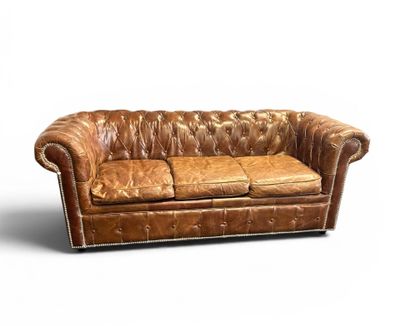 an image of a brown leather couch sitting on top of a white floor