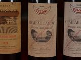 three bottles of wine are lined up on a table