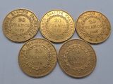four gold coins with the names of different countries on them