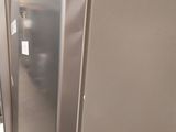 a silver refrigerator in the middle of a room