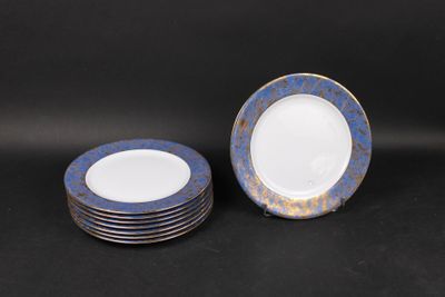 six blue and white plates with gold rims on a black background
