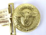 a gold belt buckle with a gold eagle on it