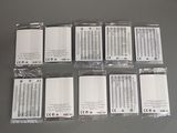 several pieces of cell phones are wrapped in plastic and sitting on a table