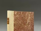 an old book with a brown cover sitting on top of a table