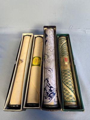 several rolls of paper are in a box on a table