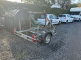 a trailer with a water tank attached to it in a parking lot