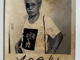 an old photo of a man with glasses and a t - shirt